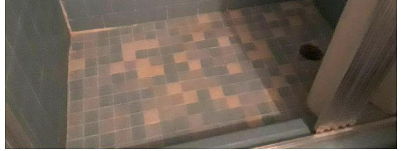 The same tiled shower floor bright and scrubbed after cleaning