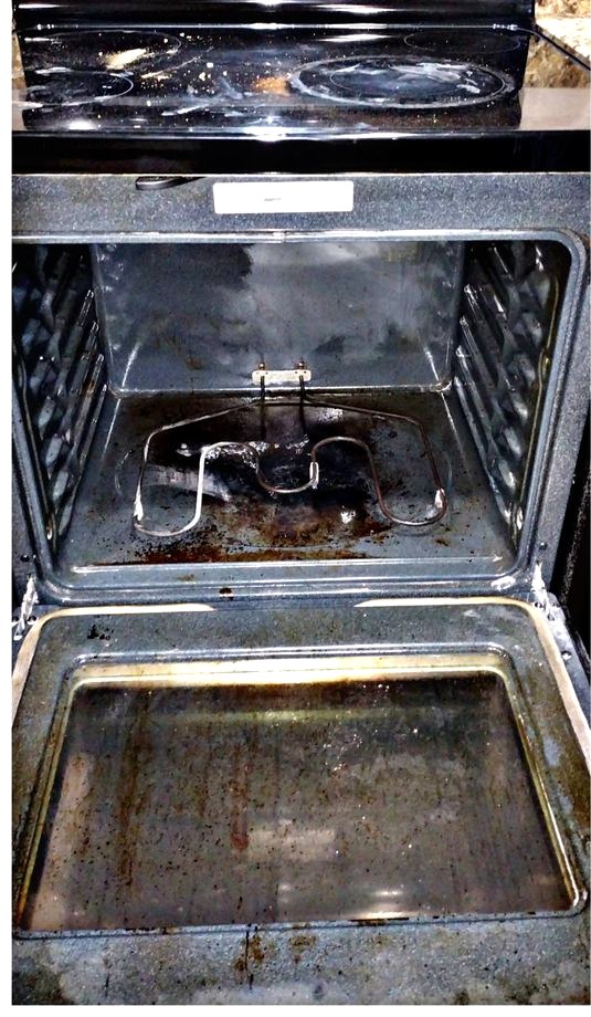 Oven interior caked with baked-on grease before cleaning